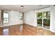 Light-filled living room featuring hardwood floors, neutral walls, and sliding door access to an outdoor patio at 816 Kittiwake Ln., Murrells Inlet, SC 29576