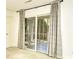 Neutral carpeted room with white walls, a door, and sliding glass doors to an outside patio at 816 Kittiwake Ln., Murrells Inlet, SC 29576