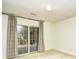 Room featuring neutral carpet, white walls, and sliding glass doors that open to an outdoor patio at 816 Kittiwake Ln., Murrells Inlet, SC 29576