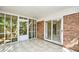 This sunroom features tile floors, a sliding glass door, brick siding, and screen windows at 816 Kittiwake Ln., Murrells Inlet, SC 29576