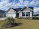 Charming single-story home with a two-car garage, manicured lawn, and decorative stone accents at 930 Padgett Lane, Conway, SC 29526