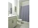 Bathroom with decorative bath tub curtain, toilet, single vanity with granite countertop, and tiled floors at 932 Mildred Ct., Murrells Inlet, SC 29576