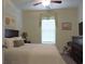 Bright bedroom featuring a queen size bed, dresser, ceiling fan, and carpeted floors at 932 Mildred Ct., Murrells Inlet, SC 29576