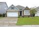 Charming single Gathering home features a two-car garage, stone accents, and manicured front yard at 932 Mildred Ct., Murrells Inlet, SC 29576