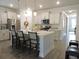 Spacious kitchen featuring white cabinets, stainless steel appliances, and a large center island with seating at 932 Mildred Ct., Murrells Inlet, SC 29576
