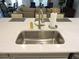 Well-designed kitchen island with a stainless steel sink and ample countertop space for meal preparation at 932 Mildred Ct., Murrells Inlet, SC 29576