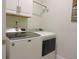Laundry room with new, front loading, Maytag washer and dryer with white cabinets at 932 Mildred Ct., Murrells Inlet, SC 29576