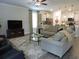 Inviting living room with a comfortable sofa, TV, and seamless flow to the kitchen at 932 Mildred Ct., Murrells Inlet, SC 29576