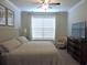 Bright main bedroom with a bed, dresser, and chair beneath a window with blinds at 932 Mildred Ct., Murrells Inlet, SC 29576