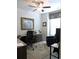 Home office features a ceiling fan, blue accent chair, wooden cabinets and marble countertops at 932 Mildred Ct., Murrells Inlet, SC 29576