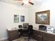 Home office with custom desk and cabinets featuring marble countertops, rug, and ceiling fan at 932 Mildred Ct., Murrells Inlet, SC 29576