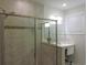 Bathroom featuring tiled shower enclosure with glass door, shower head, and tiled walls at 932 Mildred Ct., Murrells Inlet, SC 29576