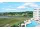 Scenic aerial shot of a waterfront property with a swimming pool and lush green landscape at 9400 Shore Dr. # 523, Myrtle Beach, SC 29572
