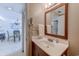 Bathroom with a wooden vanity, a large mirror and a doorway to another room at 9400 Shore Dr. # 523, Myrtle Beach, SC 29572
