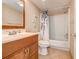Bathroom with a wooden vanity and a shower/tub combination with leaf-themed shower curtain at 9400 Shore Dr. # 523, Myrtle Beach, SC 29572
