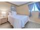 Cozy bedroom features a bright window, white bedspread, and a wicker bedside table at 9400 Shore Dr. # 523, Myrtle Beach, SC 29572