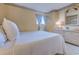 Comfortable bedroom with a white bedspread, wood floors, and wicker bedside table at 9400 Shore Dr. # 523, Myrtle Beach, SC 29572