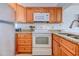 Bright kitchen with stainless steel appliances and wood cabinetry at 9400 Shore Dr. # 523, Myrtle Beach, SC 29572