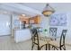 Kitchen and dining nook featuring modern appliances, granite counters, and an artistic light fixture at 9400 Shore Dr. # 523, Myrtle Beach, SC 29572