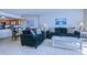 Living room and kitchen featuring tiled floors, cozy couches, and ample natural light at 9400 Shore Dr. # 523, Myrtle Beach, SC 29572
