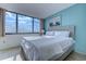 Bright main bedroom with large windows and a beach painting at 9400 Shore Dr. # 523, Myrtle Beach, SC 29572