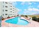 Inviting outdoor pool area with plenty of lounge chairs and beautiful views of the ocean and coastline at 9400 Shore Dr. # 523, Myrtle Beach, SC 29572