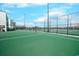 A fenced, well maintained outdoor green tennis court at 9400 Shore Dr. # 523, Myrtle Beach, SC 29572