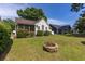 Backyard with lawn, landscaping, fire pit, and a charming screened porch at 9569 Indigo Club Dr., Murrells Inlet, SC 29576