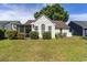 Backyard with well-maintained lawn, a screened porch, and mature landscaping at 9569 Indigo Club Dr., Murrells Inlet, SC 29576