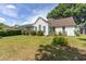 Lush backyard with mature trees and shrubs surrounding the home's exterior at 9569 Indigo Club Dr., Murrells Inlet, SC 29576