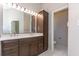 Bathroom featuring a double vanity with a large mirror, ample lighting, and neutral tiling at 9569 Indigo Club Dr., Murrells Inlet, SC 29576