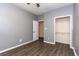 Bedroom with wood-look flooring, a ceiling fan, and closet, creating a comfortable ambiance at 9569 Indigo Club Dr., Murrells Inlet, SC 29576
