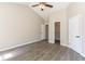 Spacious bedroom featuring a ceiling fan, a closet, and attractive wood-look flooring at 9569 Indigo Club Dr., Murrells Inlet, SC 29576