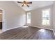 Bright bedroom with a vaulted ceiling, complemented by two windows and wood-look flooring at 9569 Indigo Club Dr., Murrells Inlet, SC 29576