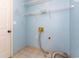 Bright laundry room with tile floor, shelves, and utility connections at 9569 Indigo Club Dr., Murrells Inlet, SC 29576