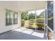 Relaxing screened porch with vinyl siding and views of the private, green backyard at 9569 Indigo Club Dr., Murrells Inlet, SC 29576