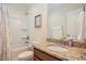 Full bathroom featuring granite countertop, framed mirror, and shower with white tub, blending functionality and style at 967 Henry James Dr., Myrtle Beach, SC 29579