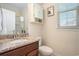 Bathroom with granite counters, a wooden cabinet, and an above-the-toilet storage unit at 967 Henry James Dr., Myrtle Beach, SC 29579