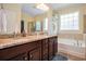 Bathroom with double sinks, granite countertops, and a soaking tub at 967 Henry James Dr., Myrtle Beach, SC 29579