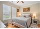 Bright bedroom with hardwood floors, two windows, and a comfortable queen-sized bed at 967 Henry James Dr., Myrtle Beach, SC 29579
