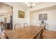 Spacious dining room with a rustic wooden table and stylish chairs, adjoining an open-concept kitchen at 967 Henry James Dr., Myrtle Beach, SC 29579