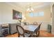 Elegant dining room featuring a wooden table, chandelier, and wainscoting, perfect for Gathering gatherings and entertaining at 967 Henry James Dr., Myrtle Beach, SC 29579