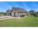 Brick house with a three-car garage, driveway, and manicured lawn, framed by a black metal fence at 967 Henry James Dr., Myrtle Beach, SC 29579