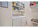 Laundry room features washer and dryer, shelving and storage space for laundry essentials, making laundry tasks easier at 967 Henry James Dr., Myrtle Beach, SC 29579