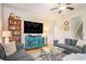 Well-decorated living room with modern furniture, hardwood floors, a large TV, and an open staircase at 967 Henry James Dr., Myrtle Beach, SC 29579