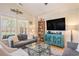 Stylish living room with vaulted ceilings, large windows, a comfortable sofa, and a media center at 967 Henry James Dr., Myrtle Beach, SC 29579