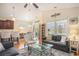 Bright living room with a ceiling fan, large windows, stylish furniture, and an open layout at 967 Henry James Dr., Myrtle Beach, SC 29579