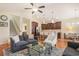 Cozy living room featuring an open layout, comfortable seating, a view of the stairs, and a modern kitchen at 967 Henry James Dr., Myrtle Beach, SC 29579