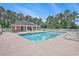 Community pool area with lounge chairs and a covered pavilion surrounded by mature trees for a resort-like experience at 967 Henry James Dr., Myrtle Beach, SC 29579