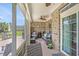Inviting sunroom features brick walls, cozy seating around a fireplace, and screened windows, perfect for relaxation at 967 Henry James Dr., Myrtle Beach, SC 29579